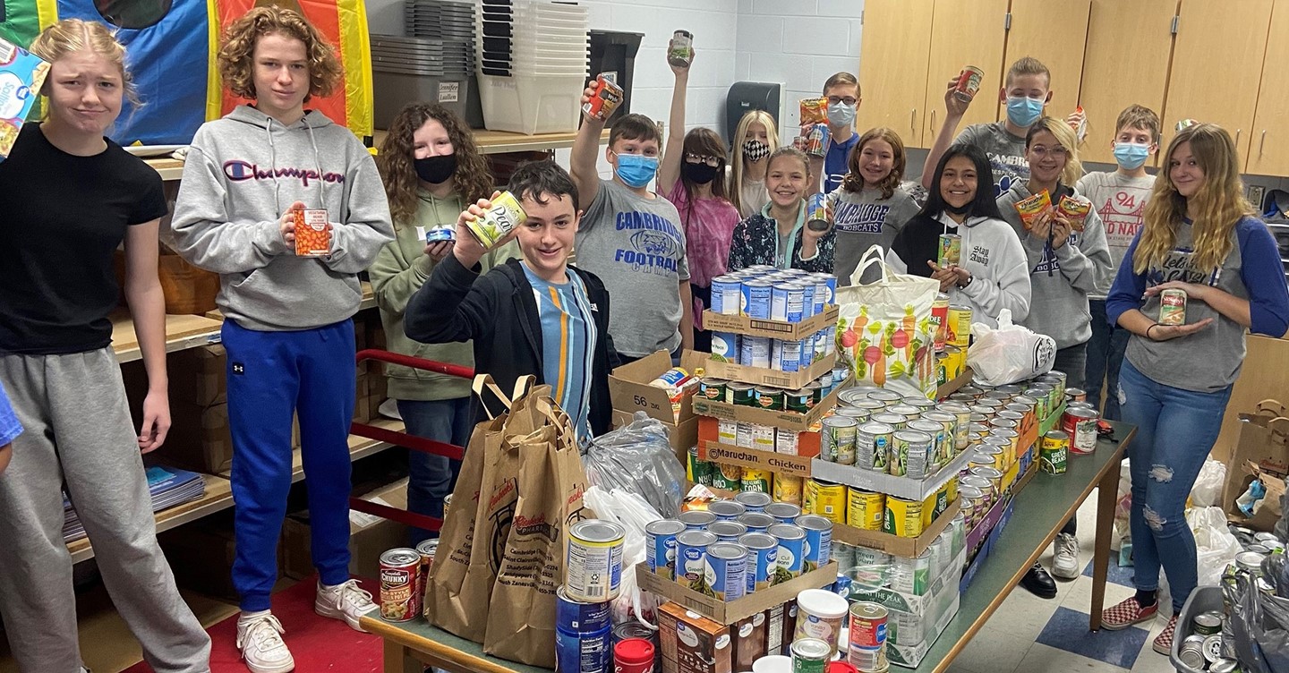 Middle School Student Council members with canned foods from food drive