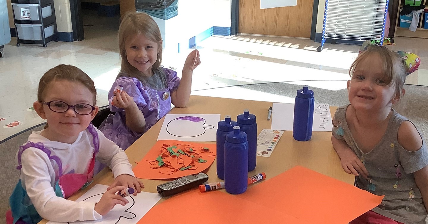Preschool students make pumpkins