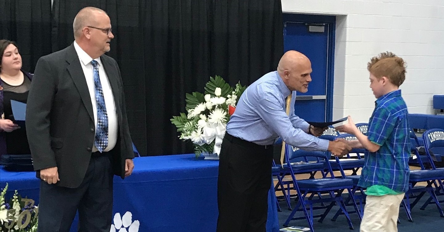 8th Grade promotion Principals present certificate