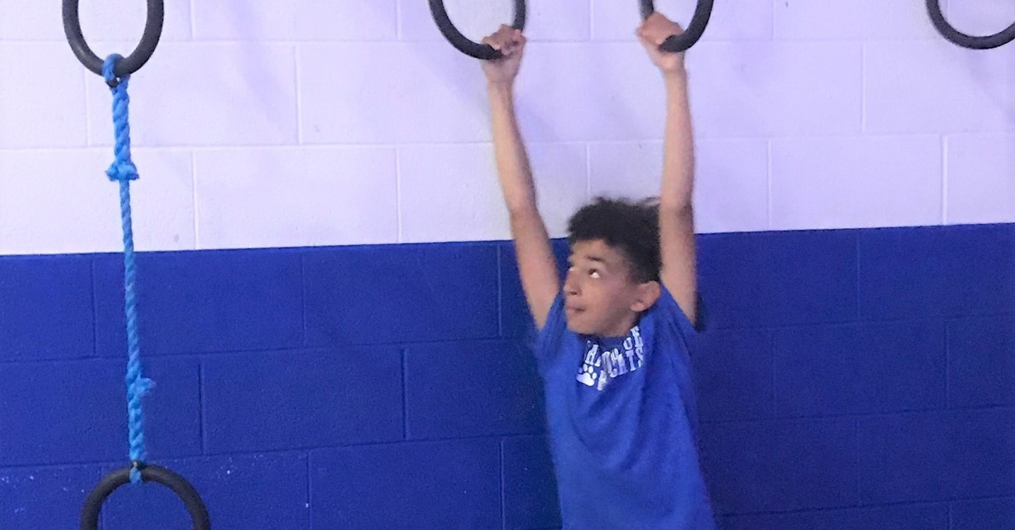 fifth grader on rings during Fun Day