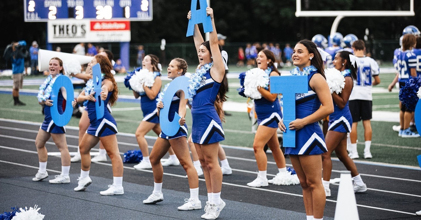 Cheerleaders on sideline at football game