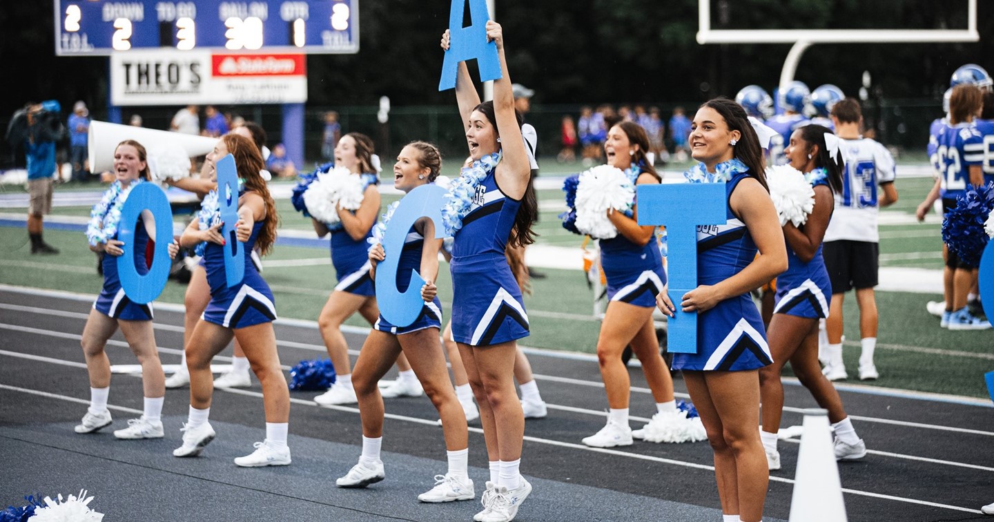 Cheerleaders on sideline at football game